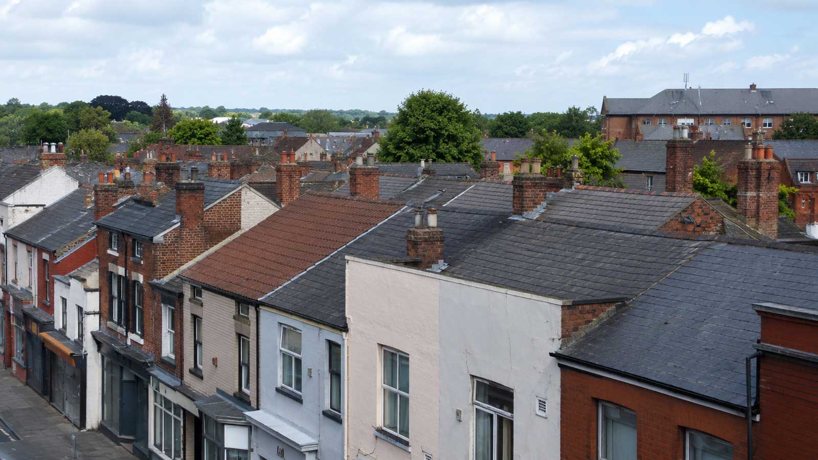 Mixed Stockport roofscape with older pitched roofs and chimney stacks